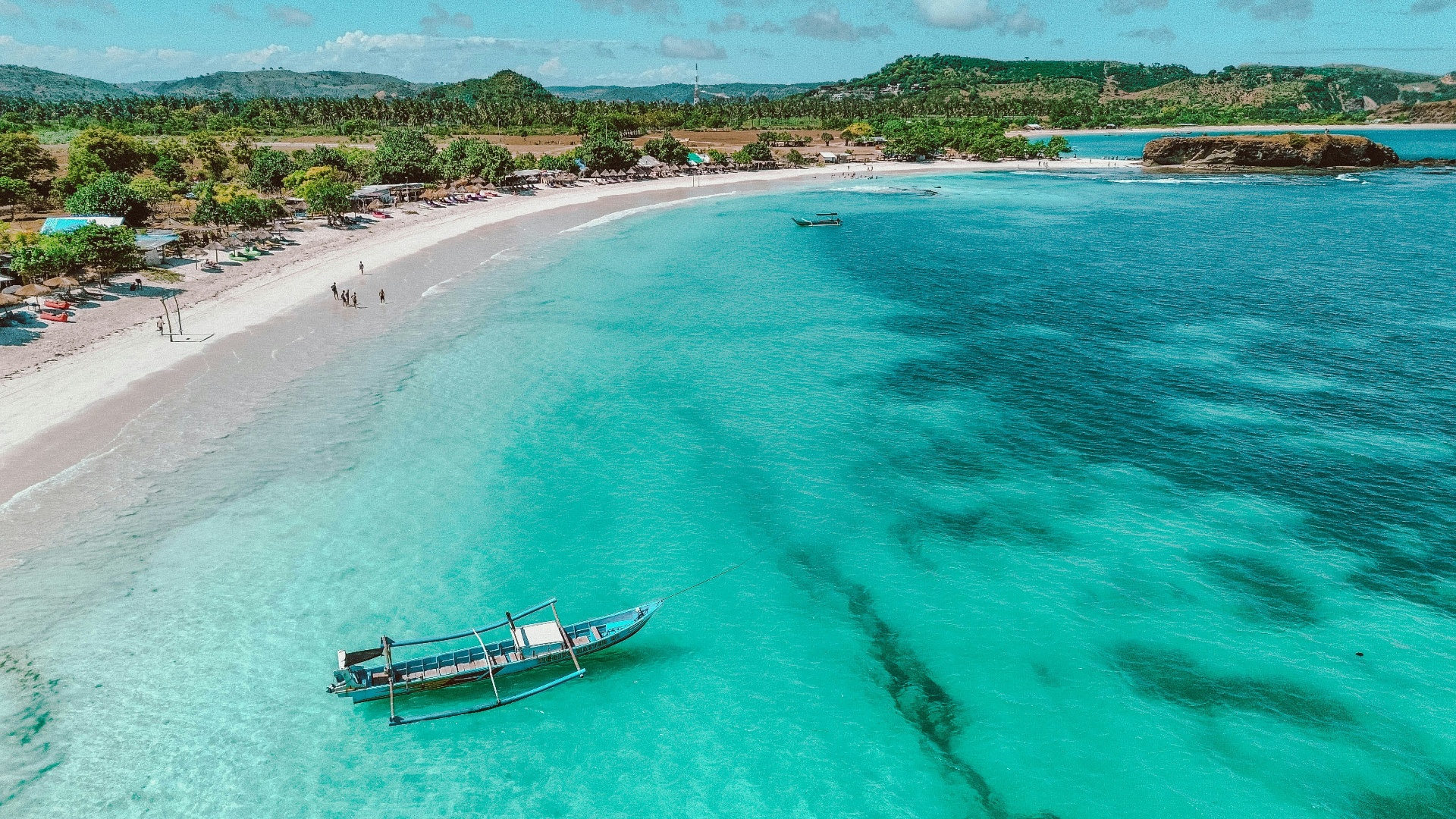 Aerial view of a turquoise bay and pink sand beach near Kuta Lombok